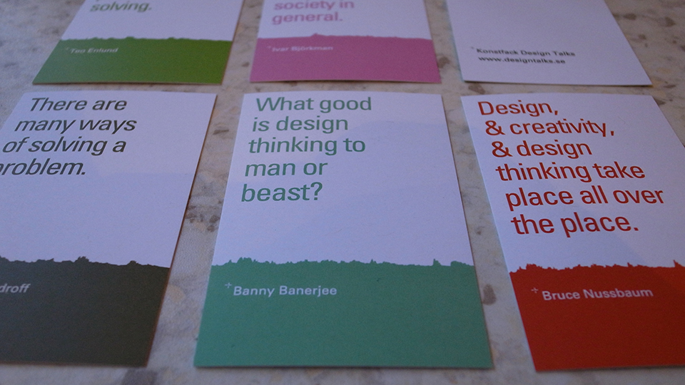 Printed interview cards laid out on a marble surface, each with a quote in coloured type above a torn sound-graph edge