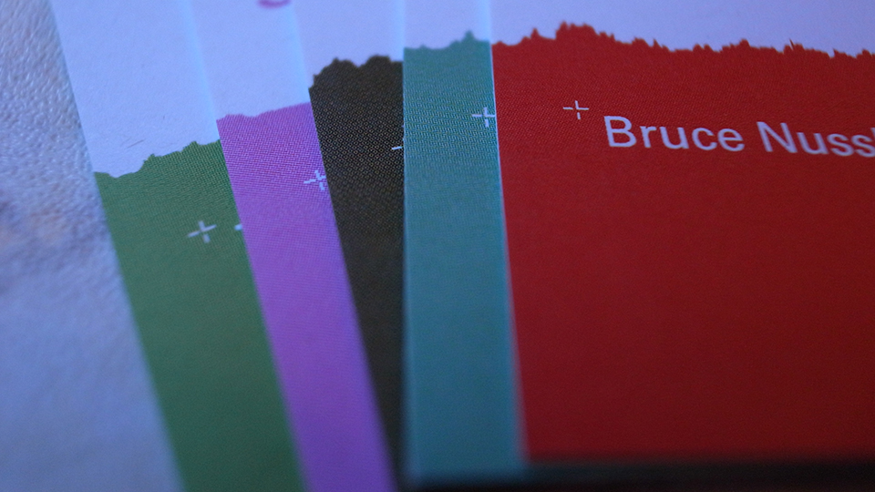 Close-up of the same cards fanned out, showing the torn sound-graph edges in green, magenta, teal and red