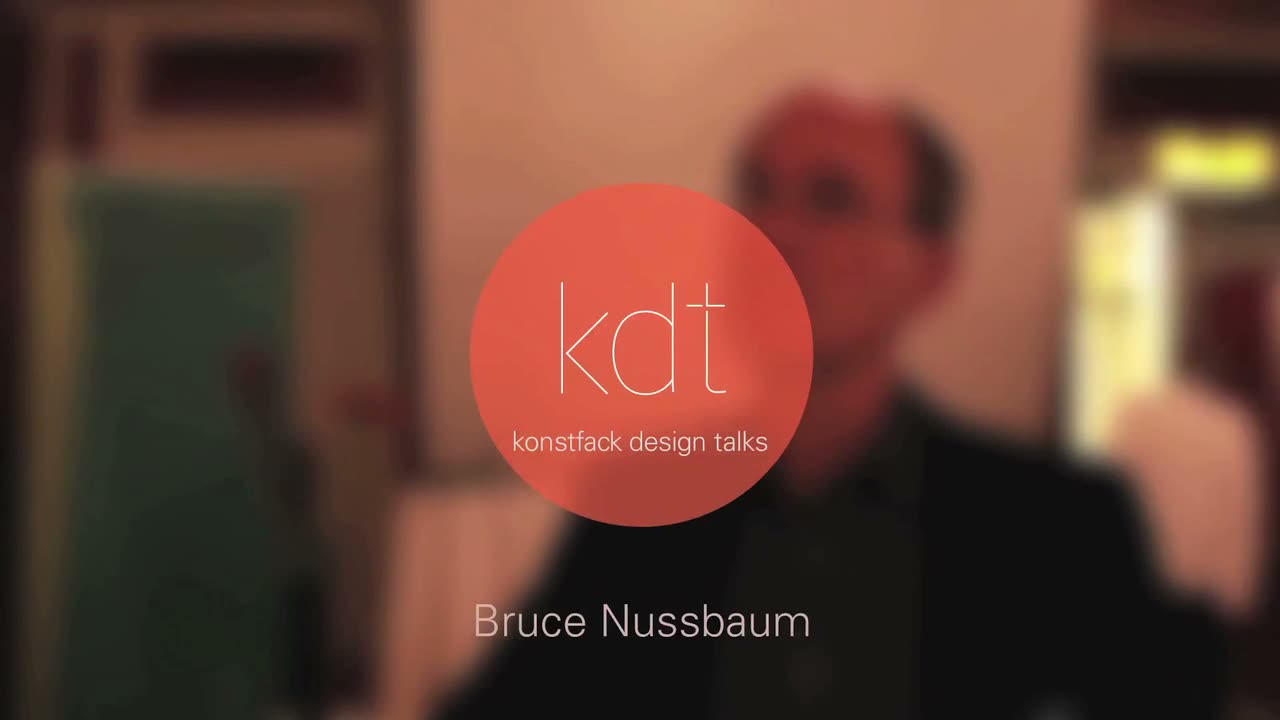 Video still: a blurred figure behind a circular orange 'kdt — konstfack design talks' logo, captioned 'Bruce Nussbaum'