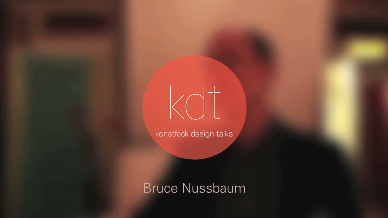 Video still: a blurred figure behind a circular orange 'kdt — konstfack design talks' logo, captioned 'Bruce Nussbaum'